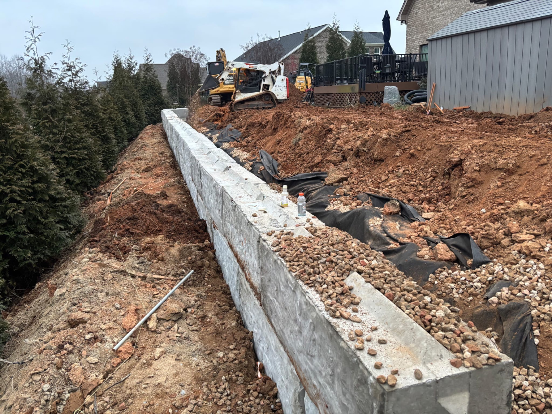 Large block retaining wall with drainage stone behind it